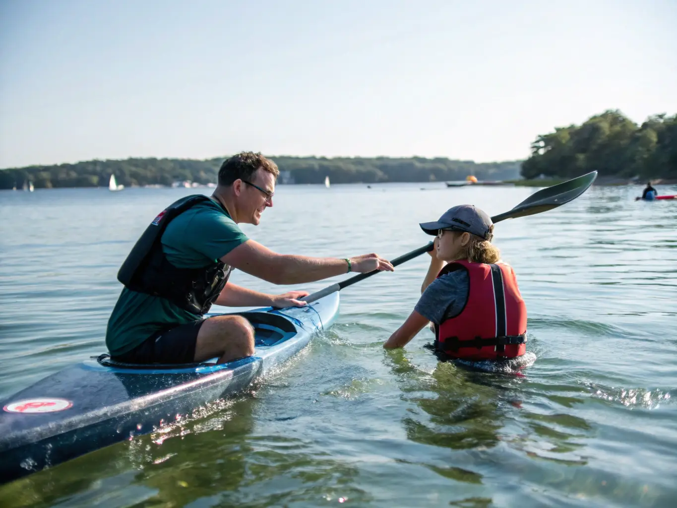 A photograph of children learning basic kayaking skills in a safe, controlled environment, with instructors nearby providing guidance and support. The image showcases the club's youth kayaking program.